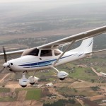 Airplane flying over rural community