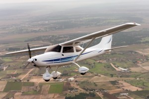 Airplane flying over rural community